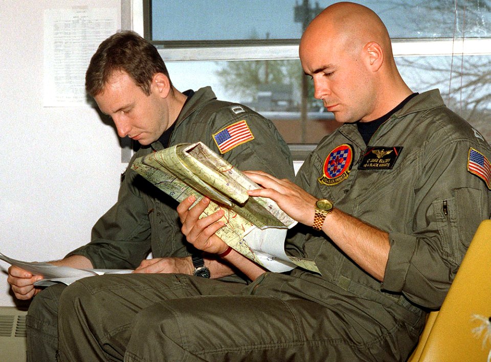 Lieutenant Jake Ellzey studies his map during a mass familiarization mission brief