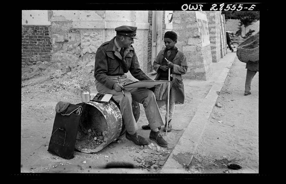 Lieutenant Milton Marx of New York City, attached to the Public Relations Office of the United States Army Ninth Air Force, does some painting in the streets of Tripoli.8d29653v
