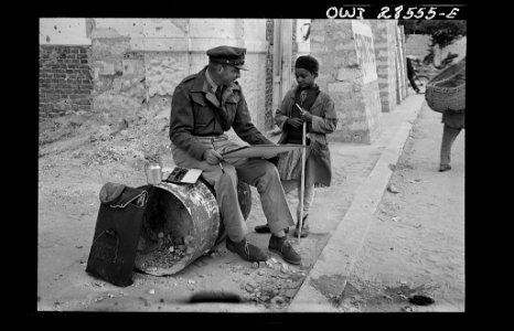 Lieutenant Milton Marx of New York City, attached to the Public Relations Office of the United States Army Ninth Air Force, does some painting in the streets of Tripoli.8d29653v