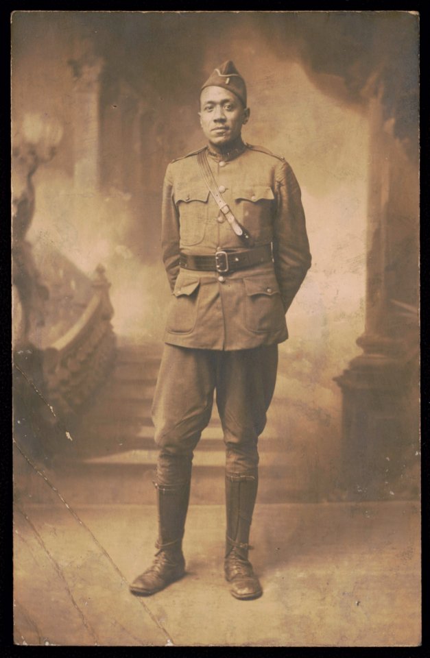 Lieutenant Wesley Herbert Jamison of 351st Machine Gun Battalion, 92nd Infantry Division in uniform and overseas cap in front of painted backdrop LCCN2017648696
