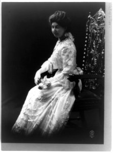 Lilian Whiting, full-length portrait, seated, facing slightly left LCCN93511219