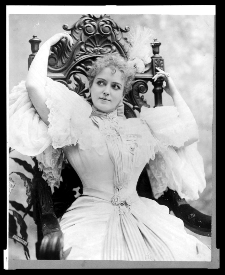 Lillian Russell, three-quarter length portrait, seated, with arms above head LCCN2005691136
