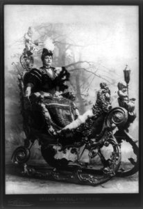 Lillian Russell, 1861-1922, full length portrait, seated in ornate sleigh, facing right; in The Grand Duchess LCCN2005686758