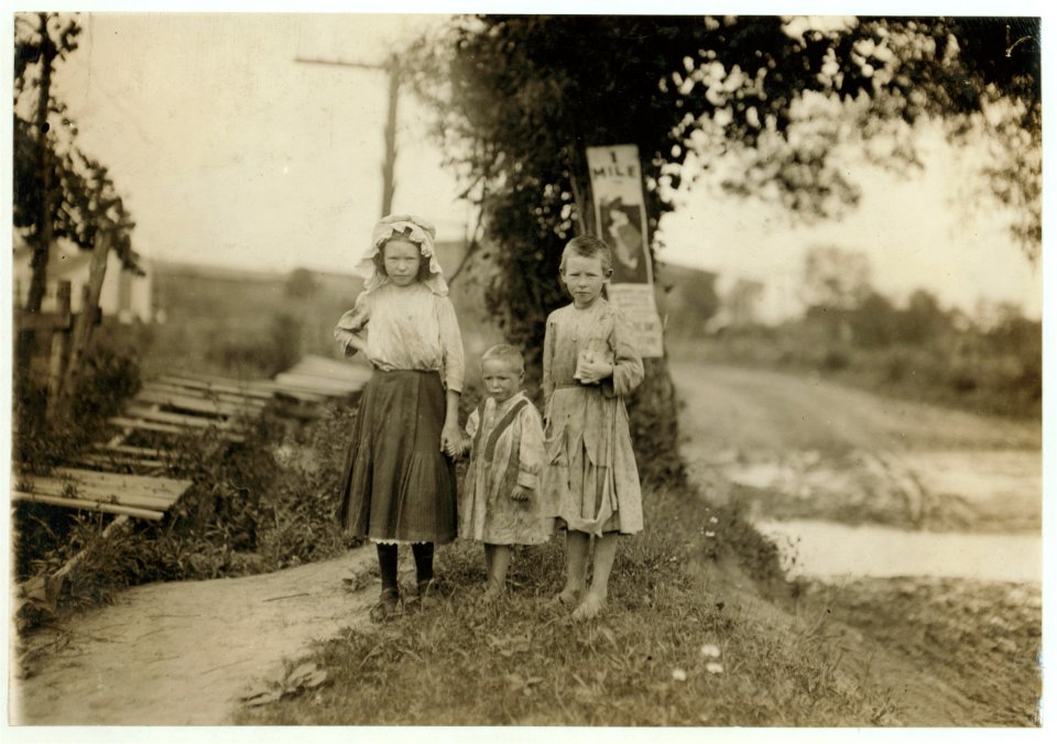 Lillie Robertson, a young spinner in Century Cotton Mills, South Boston, Va. Runs four sides. Sister Mamie (with cup) helps her and is ten years old. Baby doesn't work yet. Father works in LOC nclc.02175