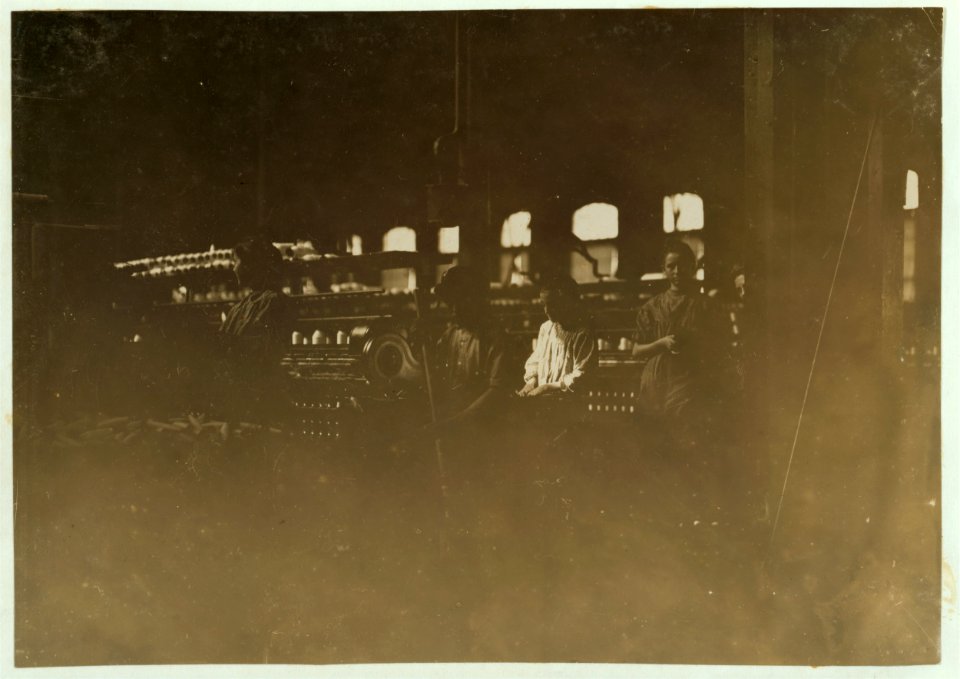 Lincoln Cotton Mill, Evansville, Ind. Boy sweeping small boy picking up and carrying away. (Bad light and shaking floors.) LOC nclc.01333
