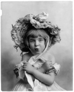 Little girl, half lgth., facing front, wearing bonnet, with arms folded and lips puckered LCCN2004668401