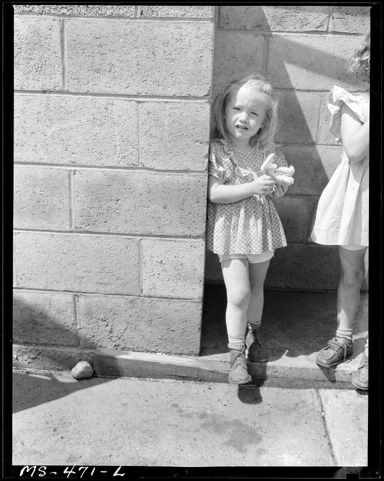 Little girl, daughter of miner eating sandwich. She lives in government housing project near King Mine. Hiawatha... - NARA - 540433
