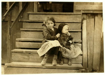 Little Julia tending the baby at home. All the older ones are at the factory. She shucks also. Alabama Canning Co.,. LOC cph.3b21318