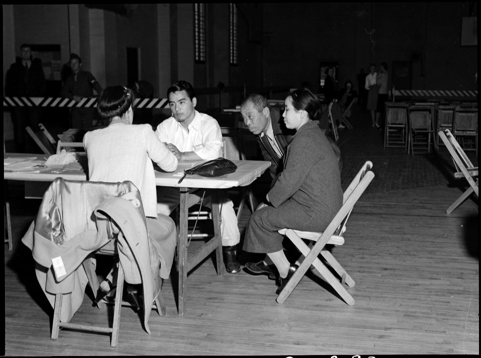 Lodi, California. A family group gives pre-evacuation data at Wartime Civil Control Administration . . . - NARA - 537630