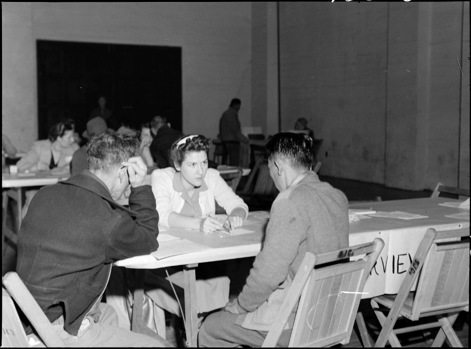 Lodi, California. Social Worker at the Wartime Civil Control Administration station advises heads o . . . - NARA - 537633