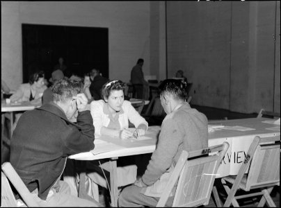 Lodi, California. Social Worker at the Wartime Civil Control Administration station advises heads o . . . - NARA - 537633
