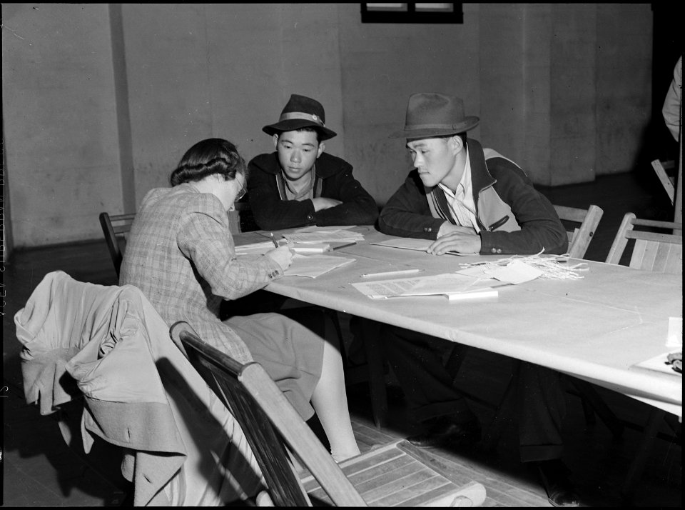 Lodi, California. Two brothers give pre-evacuation data at Wartime Civil Control Administration sta . . . - NARA - 537628