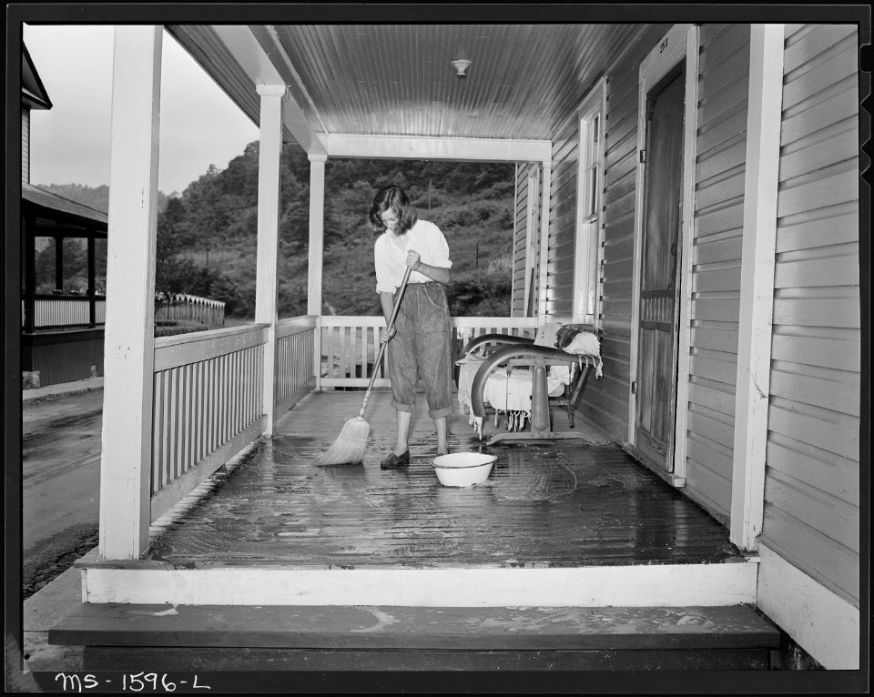 Lois, daughter of B. H. Barksdale, section foreman in mines, scrubs the front porch of their home. U.S. Coal and Coke... - NARA - 540871