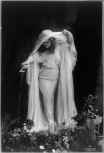 Loie Fuller, 1869-1928, full length, standing, facing left; watering flowers LCCN2005685075 photo