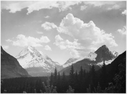 Looking across forest to mountains and clouds, In Glacier National Park, Montana., 1933 - 1942 - NARA - 519863 photo