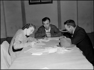Lodi, California. Father and son give pre-evacuation data at Wartime Civil Control Administration s . . . - NARA - 537627
