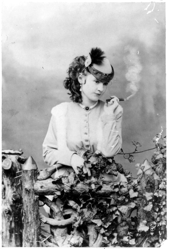 Lotta Crabtree, half-length portrait, facing right, holding cigar LCCN2005689349