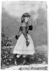 Lotta Crabtree, full-length portrait in costume for a theatrical role, smoking a cigar LCCN2004676403