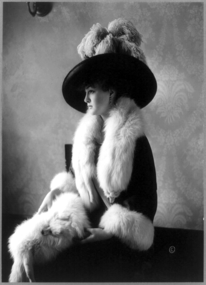 Louise Cromwell, three-quarter length portrait, seated, facing left, wearing fox furs LCCN90708175