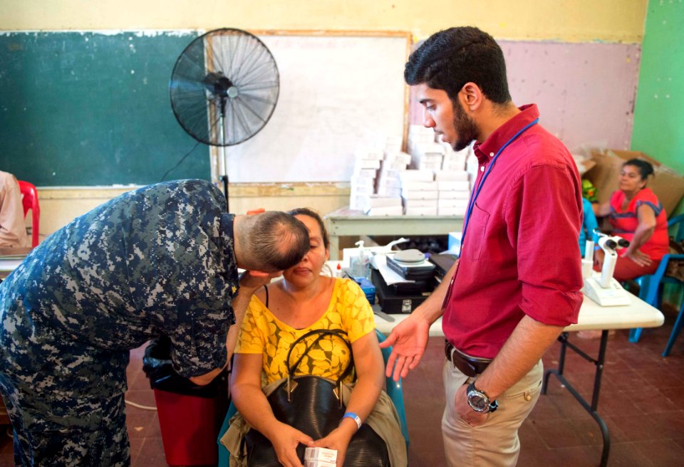 Lt. Cmdr. Paul Mayo conducts an eye exam on a host nation patient at Continuing Promise 2017 170301-N-YL073-070