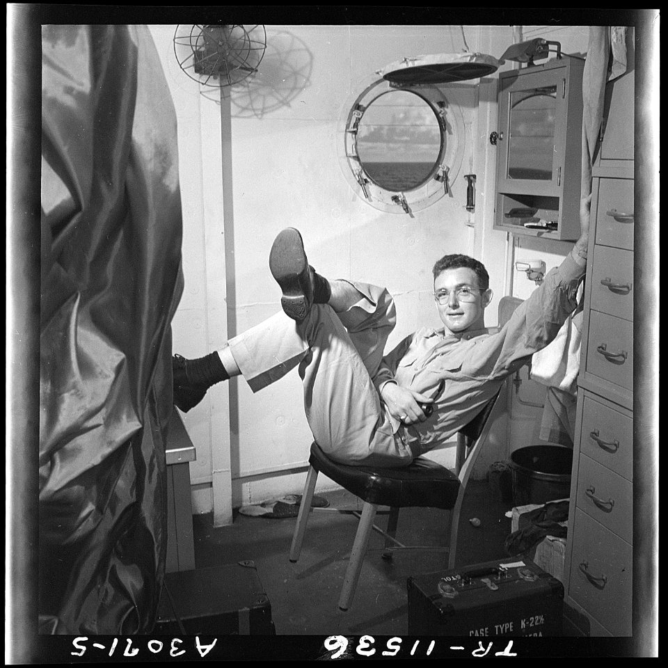 Lt. Wayne Miller relaxes in his quarters on the USS Ticonderoga (CV-14). - NARA - 520842