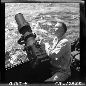 Lt.Cdr. C.F. Jacobs, formerly a leading magazine illustrative photographer, with his F-16 camera aboard the USS Iowa... - NARA - 520843