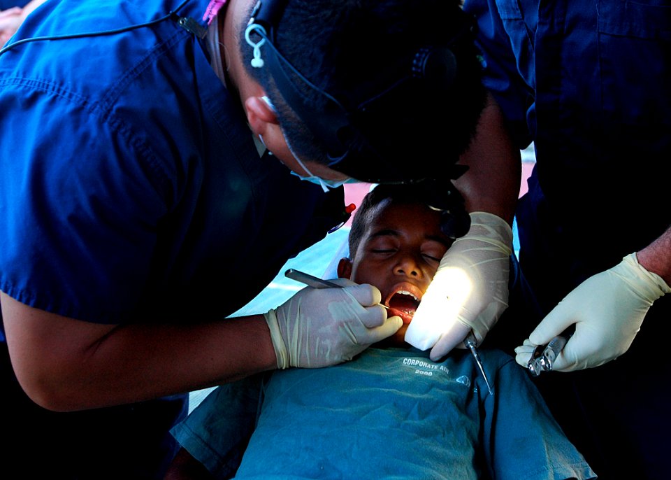 Lt. Cmdr. Paul Lim administers dental aid DVIDS55379