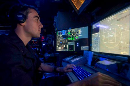 Lt. j.g. Michael Cornish stands watch in the combat information center aboard USS Normandy