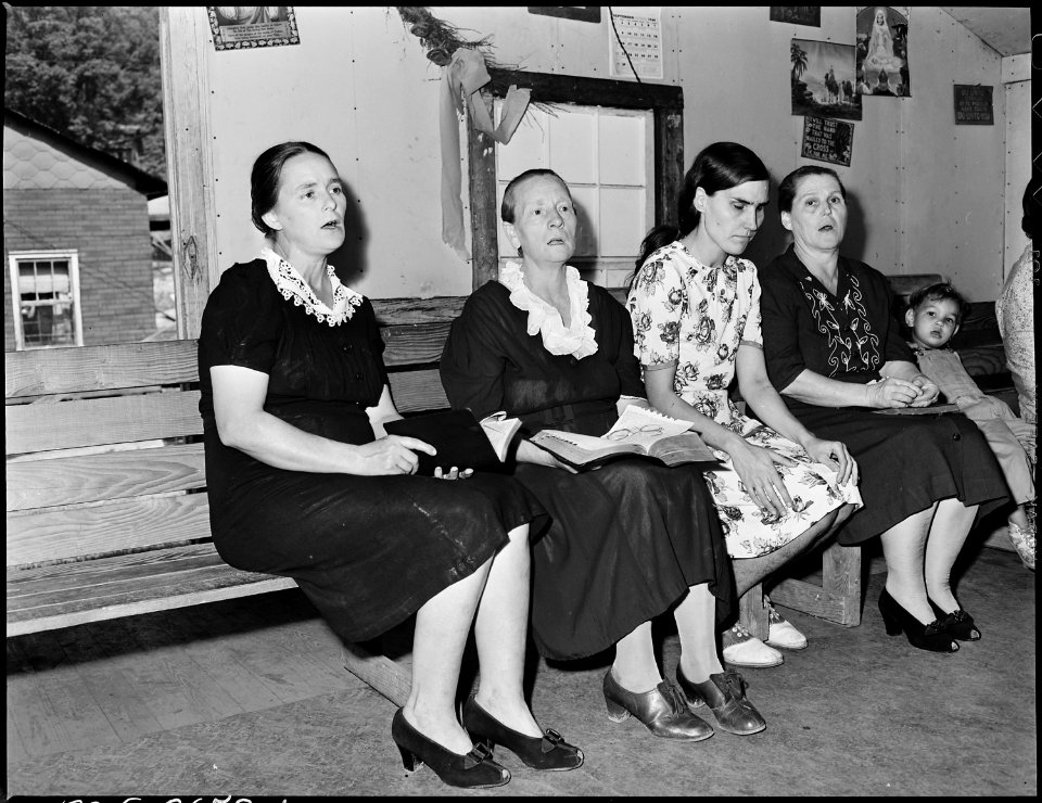 Lucy Sergent, in flowered dress, attends Sunday school at the Pentecostal Church of God. Lejunior, Harlan County... - NARA - 541347