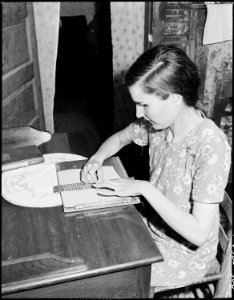 Lucy Sergent, 26, who has been blind since birth, writing. She attended the Kentucky State School for the Blind for... - NARA - 541365