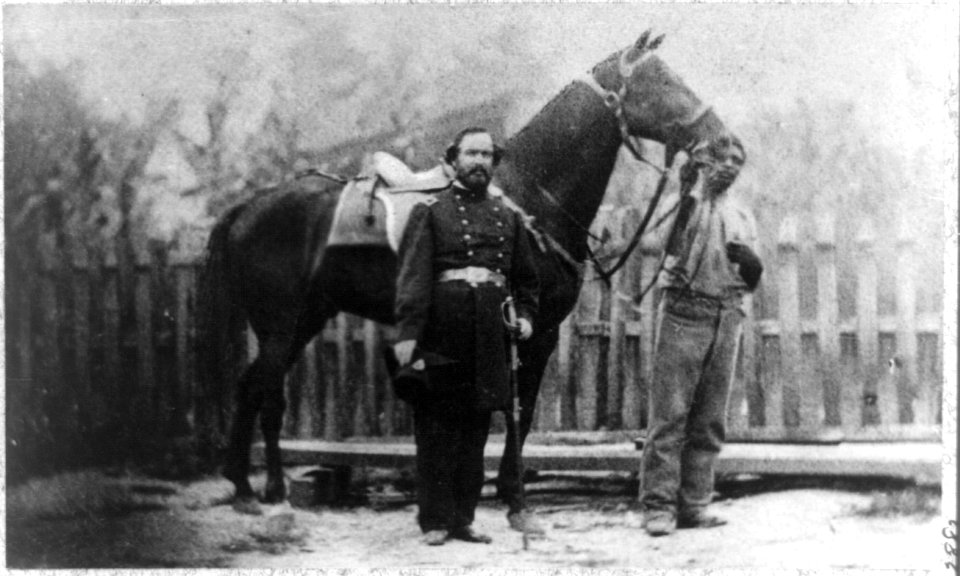 M. Miller, Colonel, 18th Mo. Infantry, full-length portrait, facing right, standing before horse held by African-American man LCCN96514390