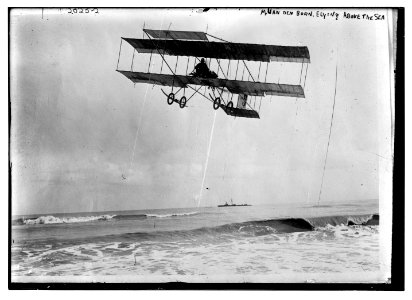 M. Van den Born flying above the sea. A ship is on the horizon. LCCN2014688116