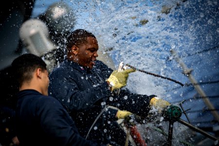 Machinist's Mate patching simulated ruptured pipe during damage control olympics aboard USS Porter (DDG-78) 180609-N-JI086-140