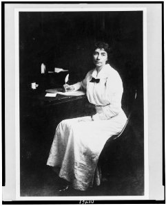 Madeline Breckinridge, full-length portrait, seated at desk, facing slightly left, with quill pen in hand LCCN94508584