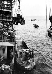 M2A4 Stuart tank is hoisted from USS Alchiba (AK-23) into a landing craft off the Guadalcanal, 7 August 1942 (80-G-10973)