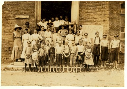 Magnolia Cotton Mills, Magnolia, Miss. Spinning room Overseer and his flock. He said, 'Every one of 'em works or helps.' I saw them all working in the morning and when the whistle blew at LOC nclc.02084