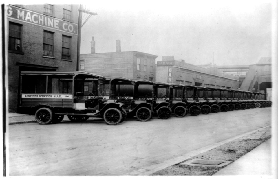 Mail trucks parked in a row in front of commercial buildings LCCN89713379