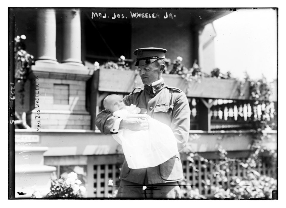 Major Joseph Wheeler, Jr., in uniform, holding baby in arms LCCN2014686282