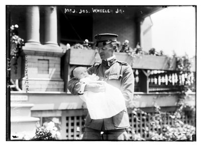 Major Joseph Wheeler, Jr., in uniform, holding baby in arms LCCN2014686282