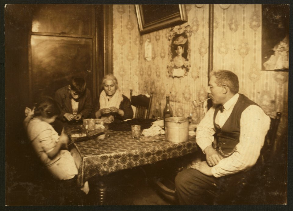 Making willow plumes under unsanitary conditions. A dirty home, the father and several friends had been rushing the growler and booze was literally flowing around over table and floor. The LOC nclc.04106