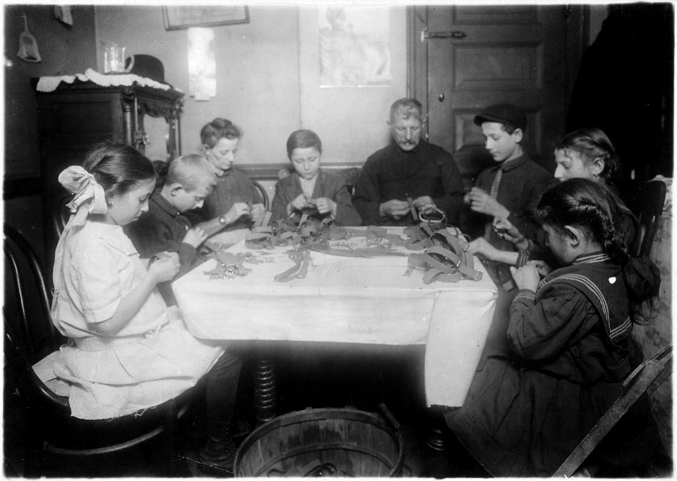 Making garters (armlets). A Jewish family and neighbors working until late at night. This happens several nights in... - NARA - 523525