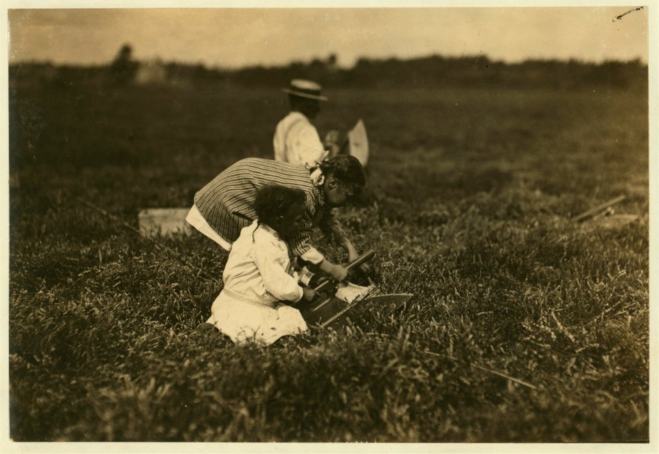Mamie, who said she was 9 and a regular picker was teaching her 6 year old sister Ada to use a scoop. LOC nclc.00116