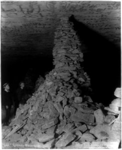 Mammoth Cave- Kentucky Monument - 2 boys looking at rocks piled to ceiling of cave LCCN2002706077 photo