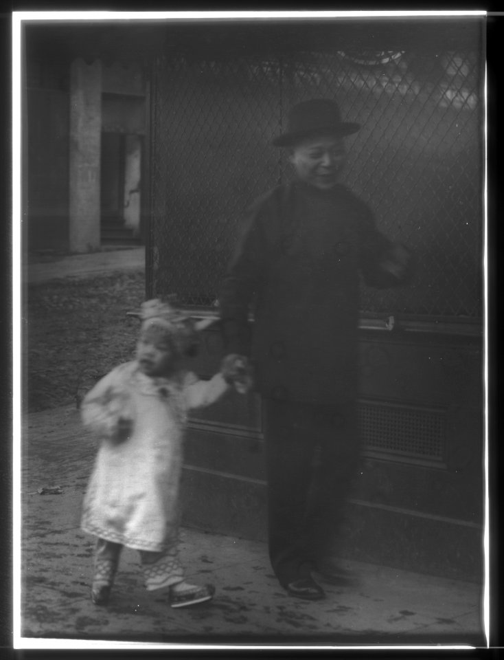 Man and a young child walking down a street, Chinatown, San Francisco LOC agc.7a55045