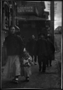 Man and a boy walking down a sidewalk with other people, Chinatown, San Francisco LOC agc.7a55040