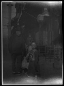 Man and children walking down a street, Chinatown, San Francisco LOC agc.7a55080