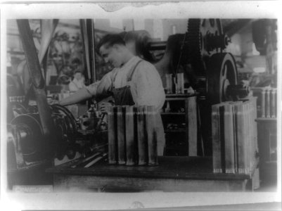 Man at machine making large cartridge cases in an American gun shop LCCN93513225