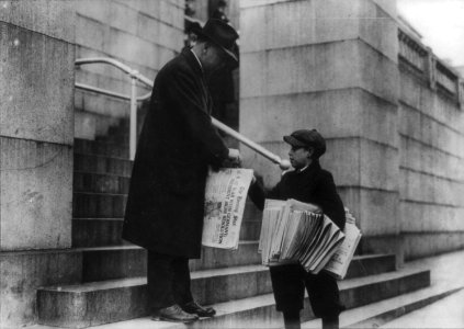 Man buying The Evening Star from newsboy, Washington, D.C. - headline reads U.S. at War with Germany LCCN2001706358