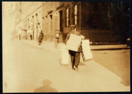 Man carrying load of caps made at home to factory, 9-11 University Place, -- Feldstein's. LOC nclc.04185