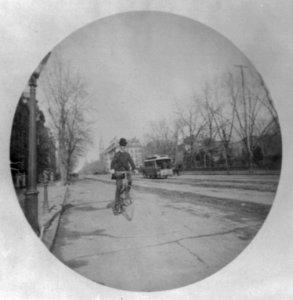 Man on bicycle on street, Washington, D.C., with horse-drawn streecar in background LCCN2003677346